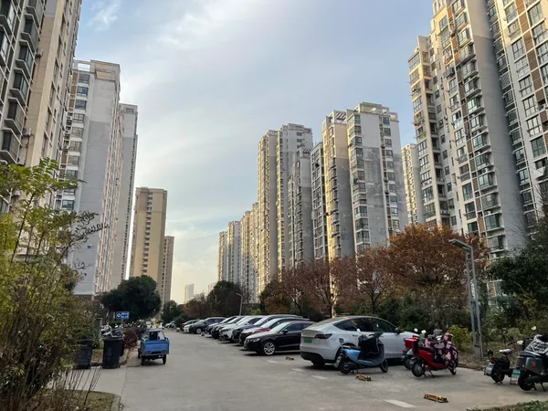 Rows of high-rise apartment buildings under an empty sky